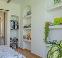 The interior of the villa with built-in storage spaces and decorative items.