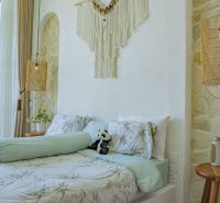 A room in a villa with a comfortable bed, decorations, and space for relaxation.