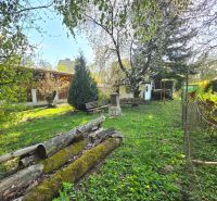 Gardens on 1st May Street in Košice - Krásna district, wooden logs and greenery.
