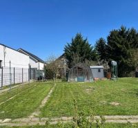 Garden with lawn, greenhouse, and trees on Hrušovská Street in Bratislava - Vrakuňa.
