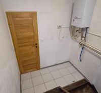 A staircase with wooden steps and a gas boiler in a 2-room apartment.