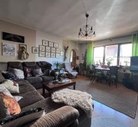 Living room in a family house with a comfortable sofa and wooden decor flooring.