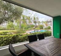 Holiday apartment with terrace, pool and garden view.