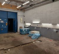 Warehouses and halls with blue doors, lighting, and materials on the floor with a wooden decor.
