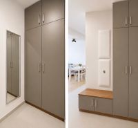 Built-in wardrobe and mirror in the hallway of a 2-room apartment with a wooden decor floor.