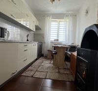 A kitchen in a 3-room apartment with a white unit and a microwave.