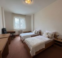 A bedroom in a 3-room apartment with separate beds and a work desk.