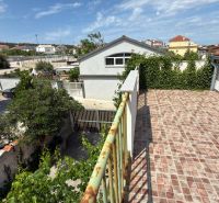 View from the terrace of a family house in Ražanac overlooking the roofs and greenery.