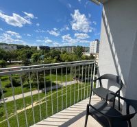 The balcony of a studio apartment on Kysucká Street in Košice with a view of greenery.
