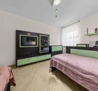 Children's room with a bed, television, and furniture, floor with wooden decor.