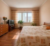 A bedroom in a 4-room apartment with a wood-patterned floor and soft lighting.