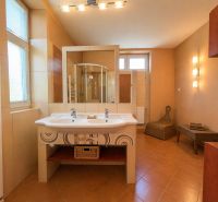 A bathroom in a 4-room apartment with a double sink and a shower.