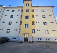 A portable building in Banská Bystrica with a parking lot in front of the entrance.