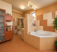 A bathroom with a shower, corner bathtub, and ceramics in a 4-room apartment.