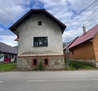 A family house in Stankovany with a stone base and a simple white facade.