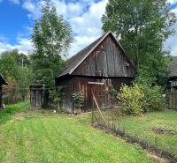 Wooden farm buildings in the garden of a family house in Stankovany.