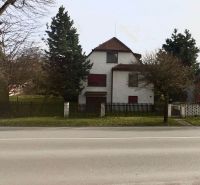 A family house on Makovického Street in Ružomberok, surrounded by trees and a fence.