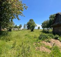 Garden and family house in Polomka with a large lawn and trees.