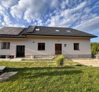 A family house in Krmeš in Liptovský Mikuláš with solar panels and a landscaped front garden.
