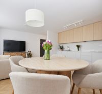 Dining table with chairs in a 4-room apartment, next to the kitchen.