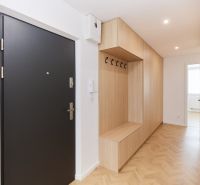Entrance hall in a 4-room apartment with wood-patterned flooring and storage space.