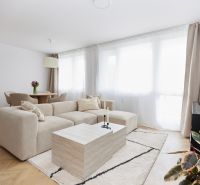 Living room with a comfortable sofa and a coffee table in a 4-room apartment.
