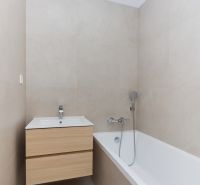 A bathroom in a 4-room apartment with a bathtub and a cabinet with a sink.