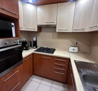 A kitchen with a corner unit and appliances in a 3-room apartment, ceramic tiles.
