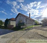 A family house in Šumiac with rural charm, surrounded by greenery and a pale blue sky.