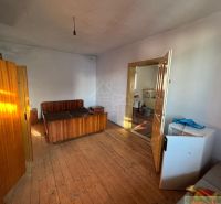 A bedroom in a family house with wooden floor decor, simple furnishings.