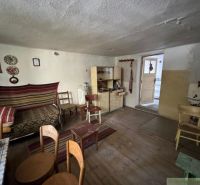 Interior of a family house with simple furniture and a wooden decor floor.