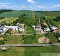 Aerial view of plots - housing in Karná, with surrounding fields and houses.