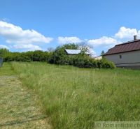 Grassy residential plots in Karna with a view of the house and blue sky.