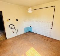 Interior of a family house with white walls and a floor with a wooden decor.