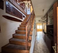 Staircase and hallway with wooden decorations in a family house.