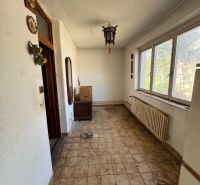 Entrance hall in a family house with tiles, wall decorations, and lighting.