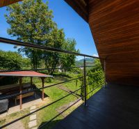The balcony of the cottage with a view of greenery and a gazebo on Klučina Street, Považská Bystrica.