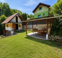 A cottage on Klučina in Považská Bystrica with a gazebo and lawn, surrounded by greenery.