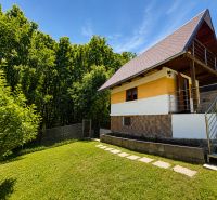 A cottage on Klučina Street in Považská Bystrica surrounded by greenery and lawn.
