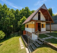 A cottage with wooden decor in Považská Bystrica at Klučina, surrounded by greenery and trees.