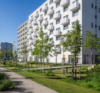 Apartment building in Bratislava - Ružinov on Ivanská cesta with a green park in the surroundings.