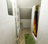 A bathroom in a family house with tiles and a shower.