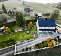 A family house in Makov with a spacious garden and trees, from a bird's-eye view.