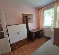 A room in a 4-room apartment with furniture and a wooden decor floor.