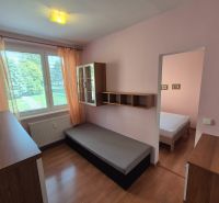 A room with a bed, cabinets, and a floor with a wooden decor in a 4-room apartment.