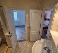 Bathroom with light ceramics and entrance to the rooms, 4-room apartment.
