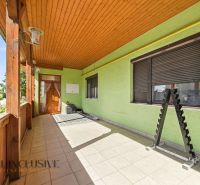 A family house in Hviezdoslavov with a decorated terrace and paving, light green plaster.