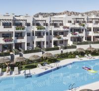 A holiday apartment in Pulpí with a pool, sunbeds, and umbrellas, surrounded by greenery.