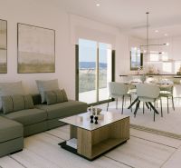 Bright living area of a holiday apartment with a sofa and dining table.