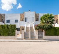 A recreational apartment in Cala Murada on Mallorca with a modern facade and a green fence.